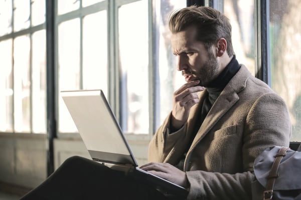 Employee engaged in training on laptop.